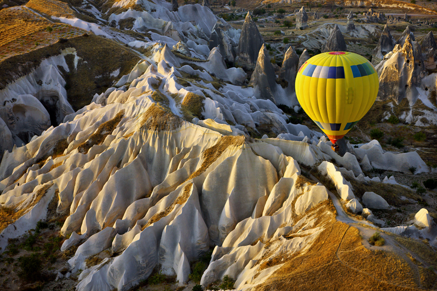 Hot air balloon flight over Cappadocia, a historical region in Central Anatolia, largely in Nevşehir Province, in Turkey.