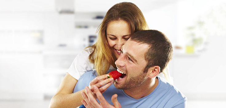 man eating strawberry fruit