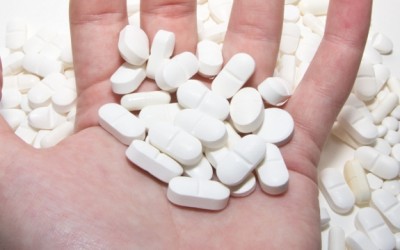 white pills in hand