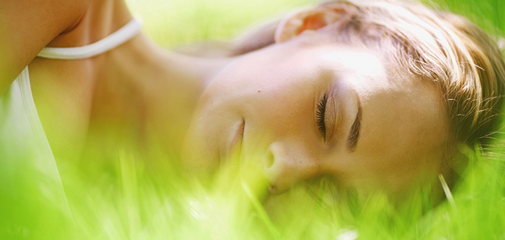 woman laying in grass