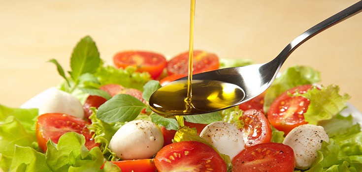 olive oil poured over salad