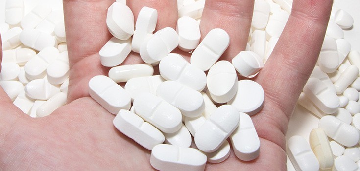 white pills in hand