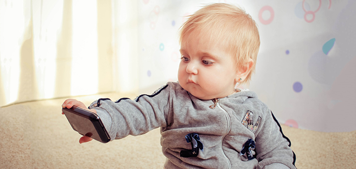 kid looking at smartphone
